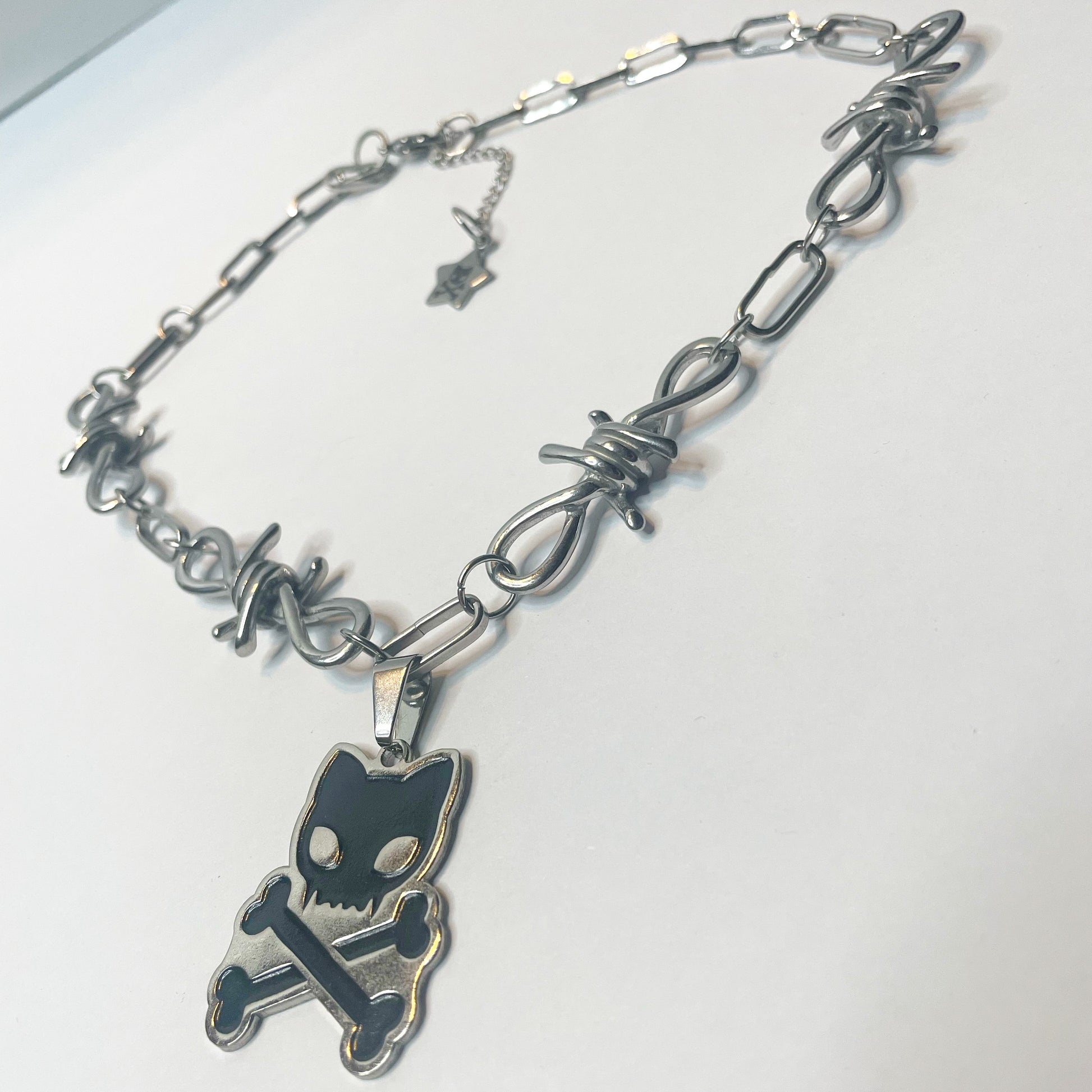 Image shows another angle of the barbed wire Toxicat necklace 