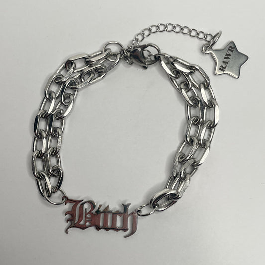 Image shows double layers rolo chunky chain bracelet with a connector charm that says bitch in old English font. The bracelet has a2” extended chain with a star shaped. Harm on the end of it 