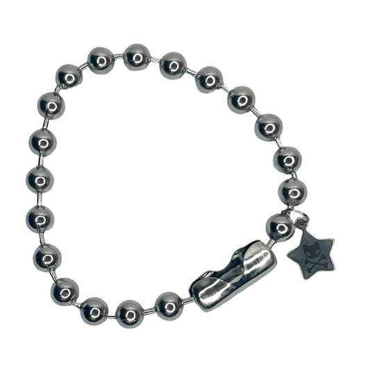 Image shows silver chunky 8 millimeter ball chain bracelet against a white background. Next to the connector is a small star shaped charm engraved with the caution toxic or the word RAWR 