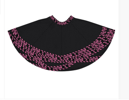 Images shows skirt back lying flat to show hot pink and black caution tape pattern 