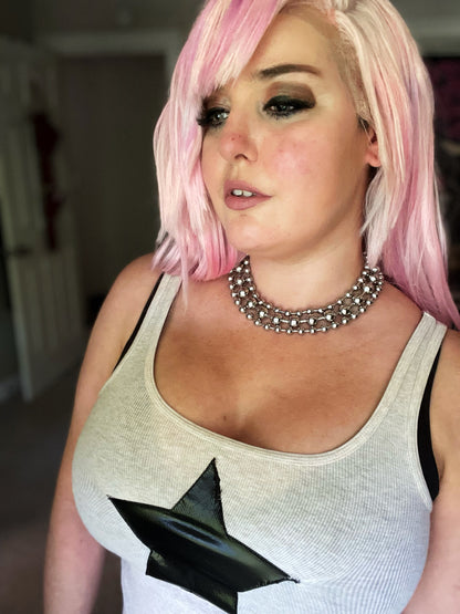 Image shows pink haired white woman wearing three layers of the ball chain necklaces in both the 8 millimeter and 12 millimeter sizes 