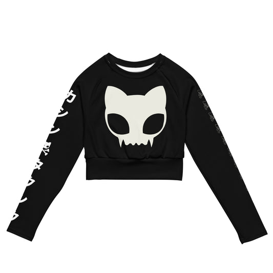 Images shows black long sleeve crop top with extra large white kitty skull on the front with katakana written down the right arm and the Caution:To8, logo down the arm 