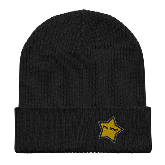 This organic ribbed beanie features an embroider gold/yellow star that says “you tried” in black Comic Sans font 